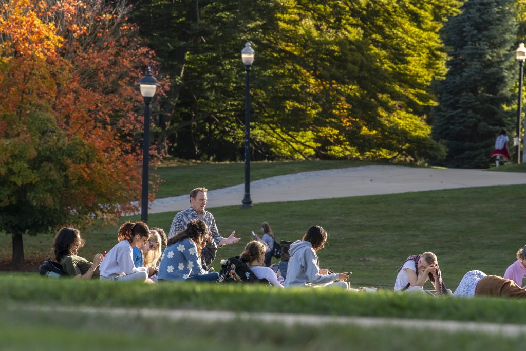 Students sitting in lawn during class