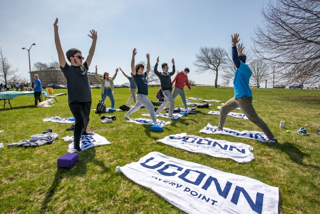 Students at the UConn Avery Point campus doing Yoga outside. April 14, 2022. (Sean Flynn)