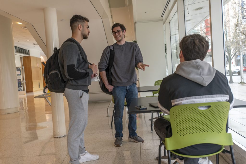A group of UConn Stamford students talking. April 6, 2022. (Sean Flynn)