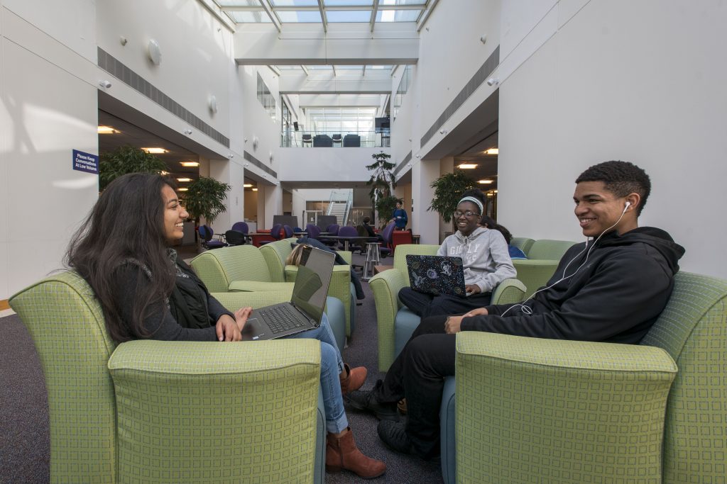 Students socializing in the library at Uconn Stamford on Oct. 17, 2018. (Sean Flynn/UConn Photo)