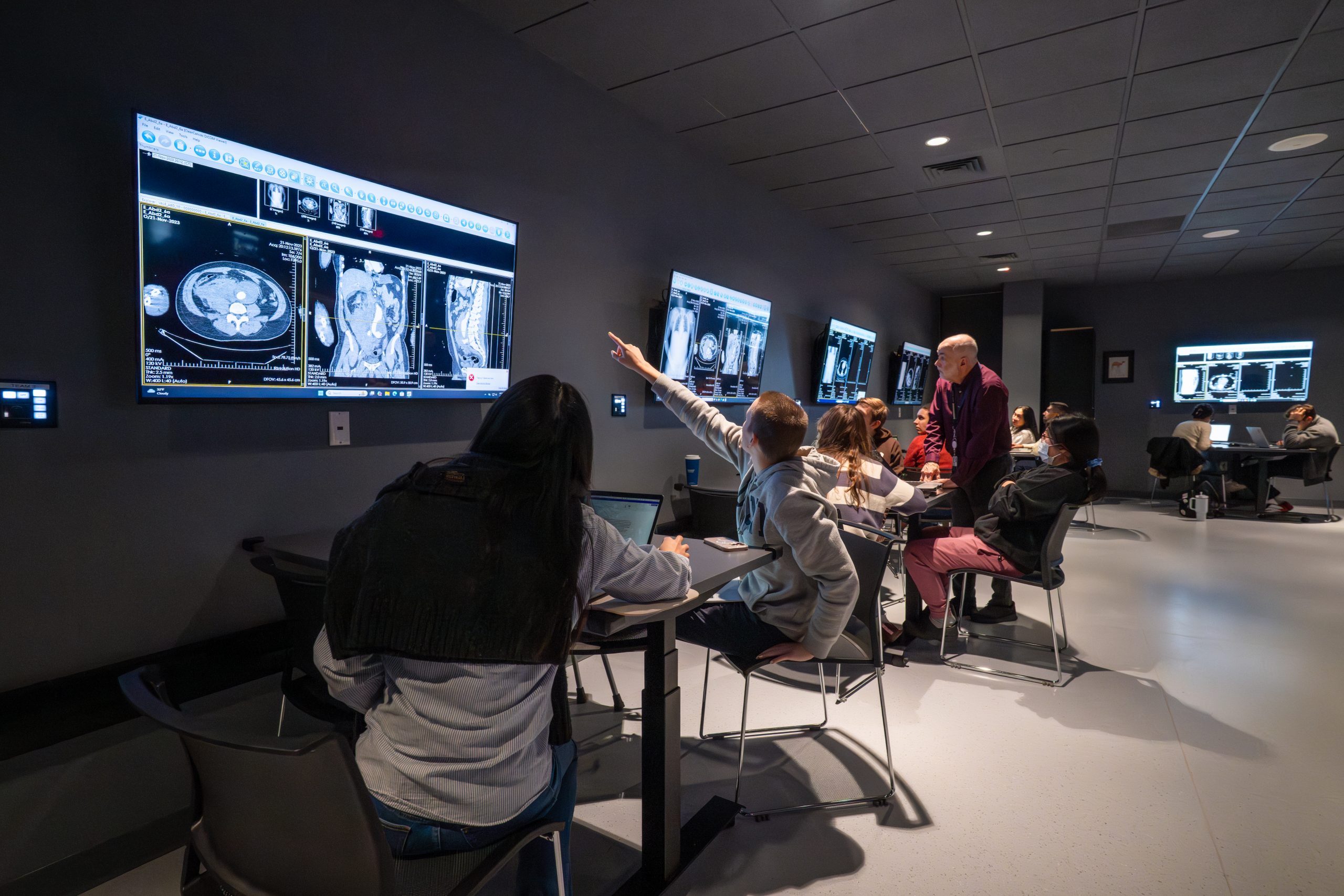 Medical and dental students review radiological scans with professor John Harrison, PhD, in the virtual anatomy lab at the UConn School of Medicine during a class on January 7, 2026.(Tina Encarnacion/UConn Health photo)