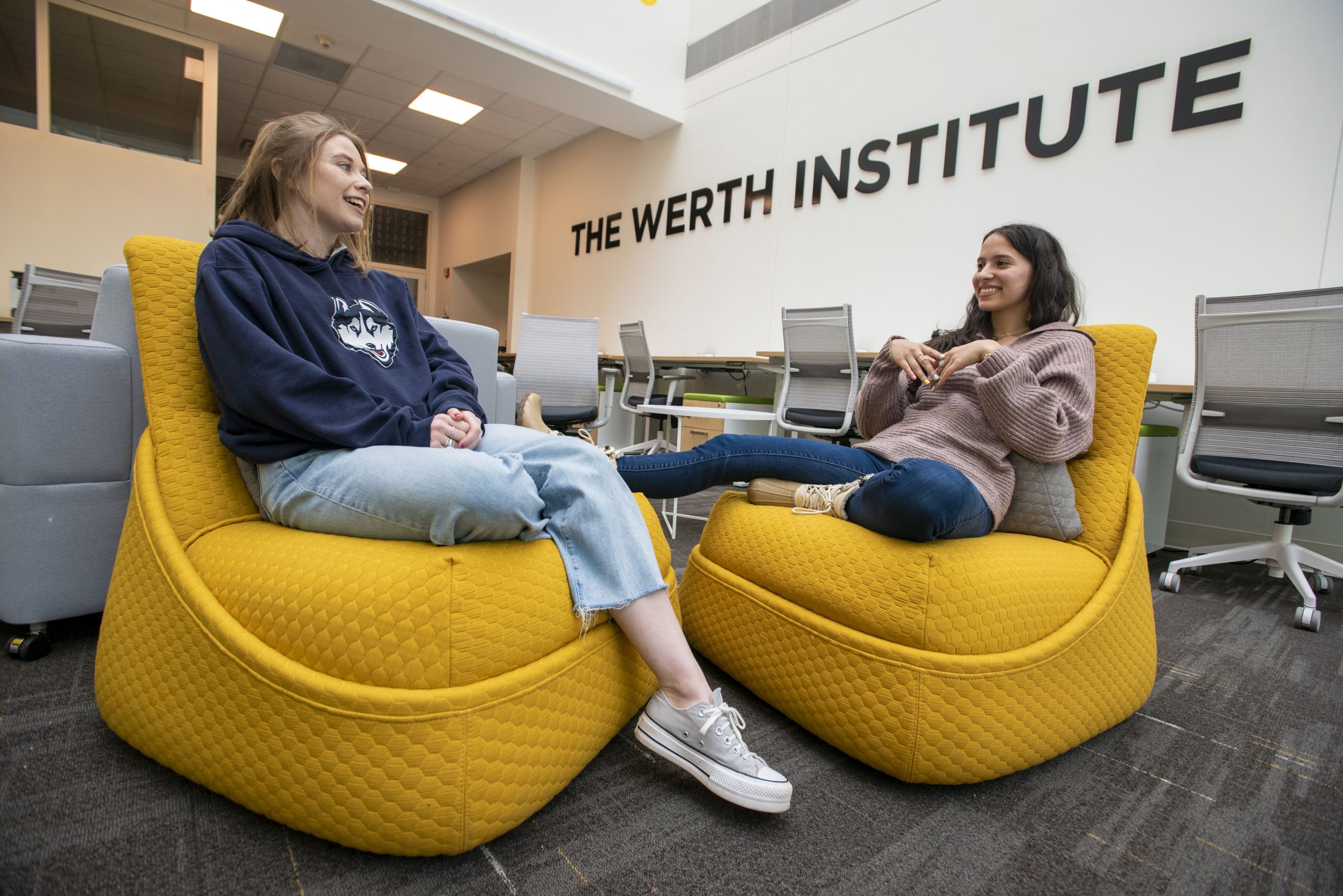 UConn Stamford students talking at the Werth Institute Suite. 