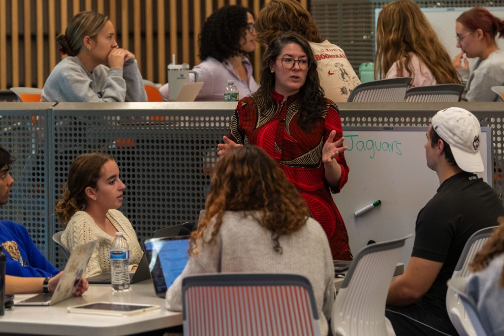 Assistant Professor Alexandra Paxton talking with a student in the Science 1 building