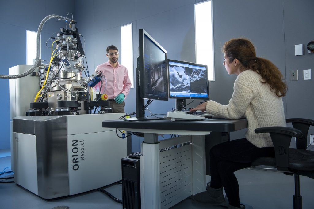 Students in Materials Sciences and Engineering using an Orion Nanofab machine at the Innovation Partnership Building